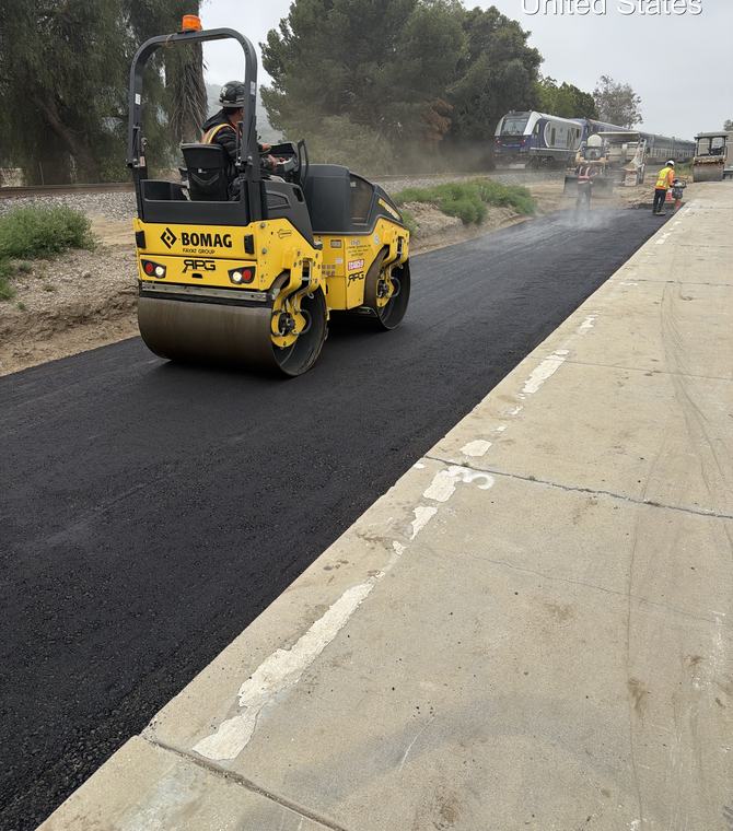 Roller compacting fresh asphalt