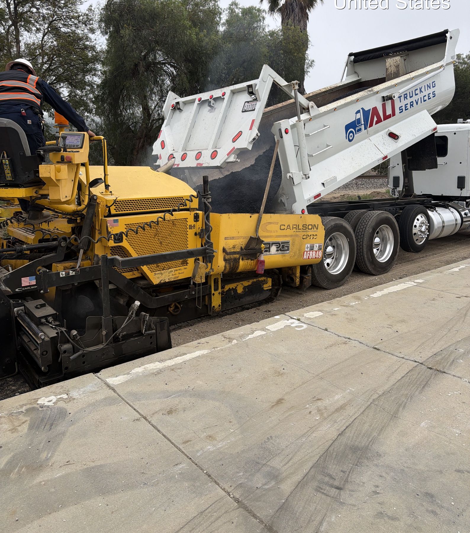 Asphalt paving operation with paver and crew