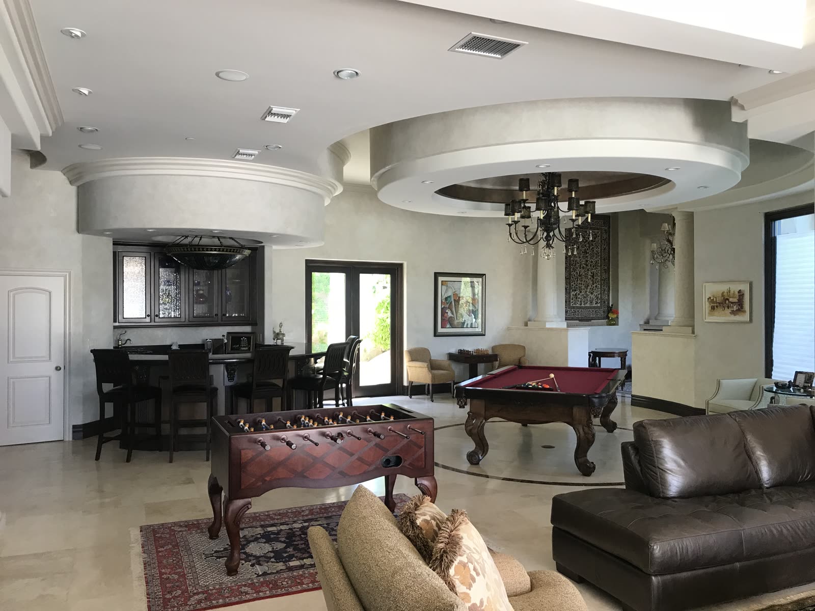 Game room with custom bar and coffered ceilings