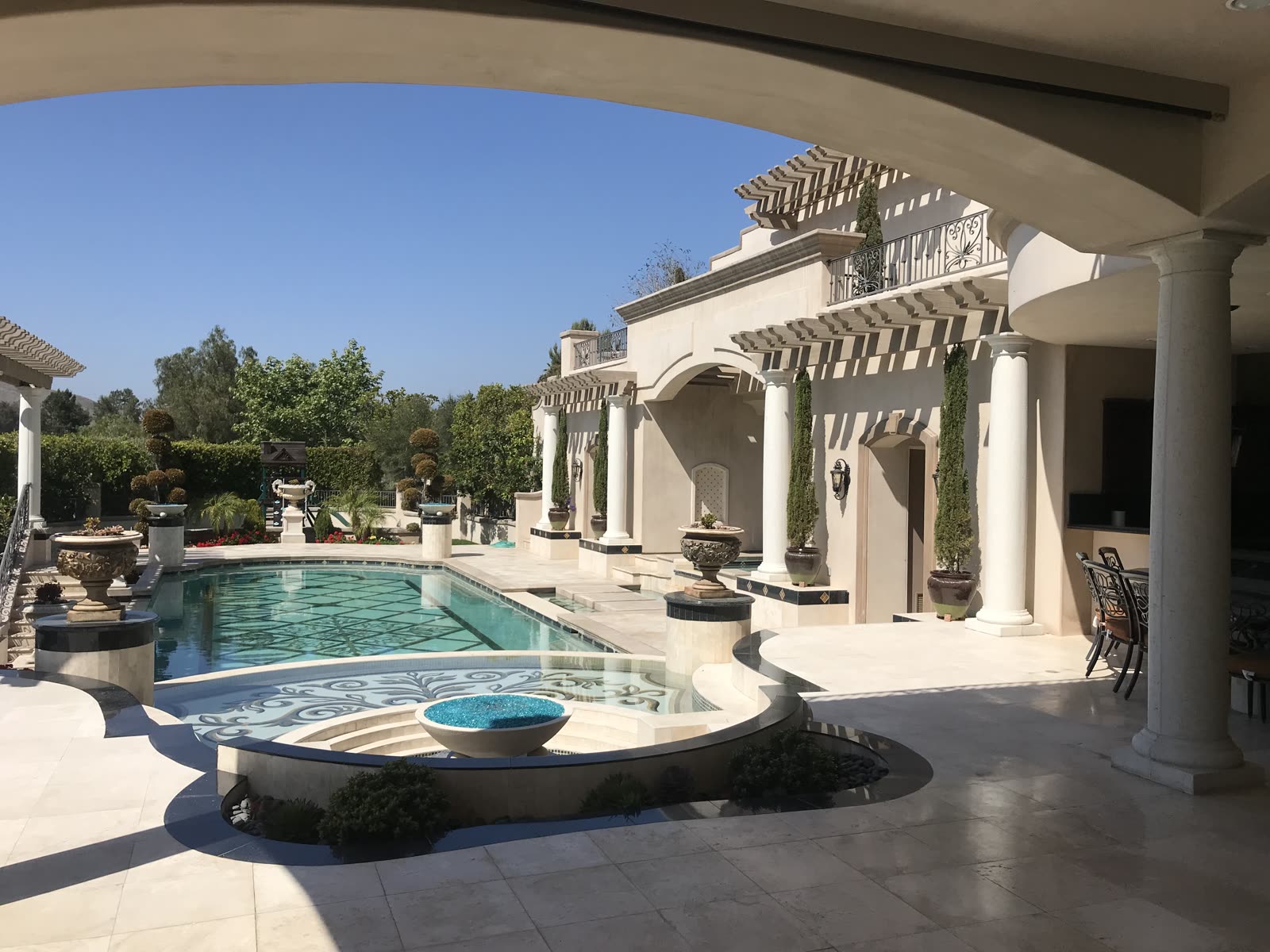Estate pool and spa with fire bowl and colonnade