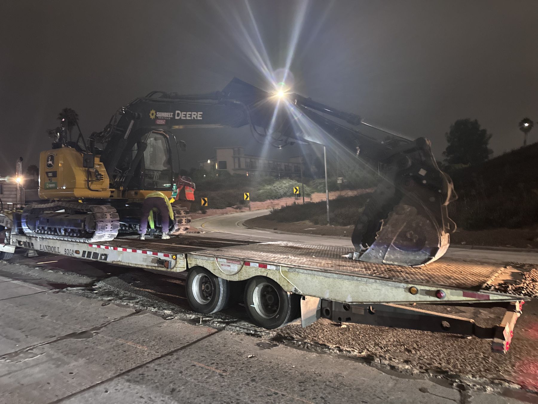 Excavator mobilizing on a lowboy trailer