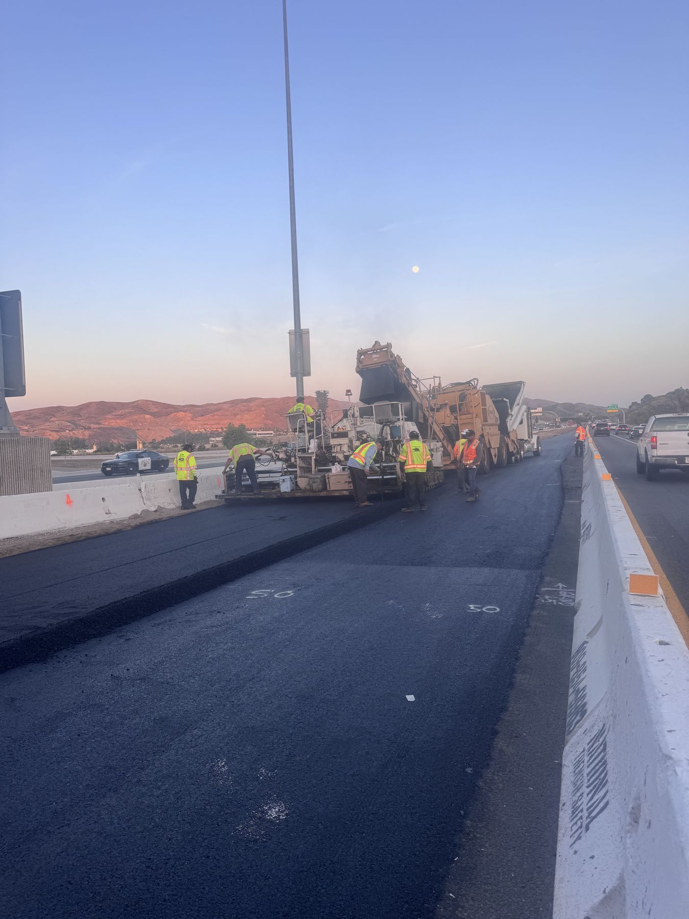 Freeway paving operation at sunrise